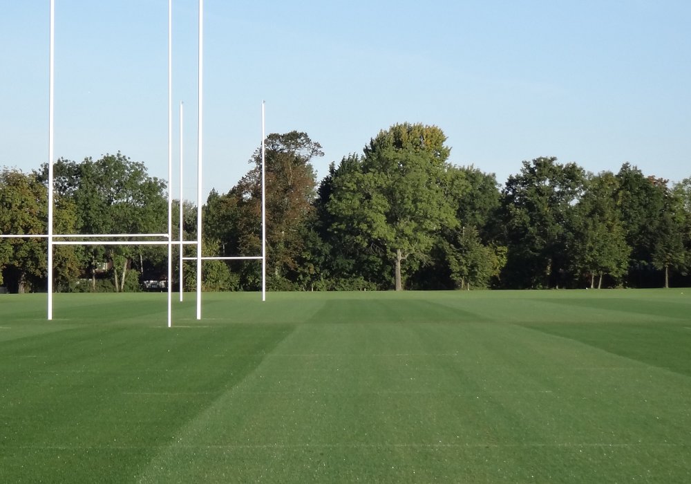 School kids playing rugby pitch